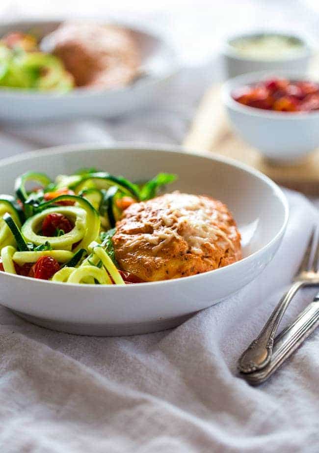 Sun-Dried Tomato Chicken with Zucchini Noodles - Zucchini noodles are tossed with roasted tomatoes, lemon, basil and Parmesan, then topped with sun-dried tomato & Greek yogurt marinated chicken for an easy, healthy weeknight meal that's under 350 calories! | Foodfaithfitness.com | @FoodFaithFit