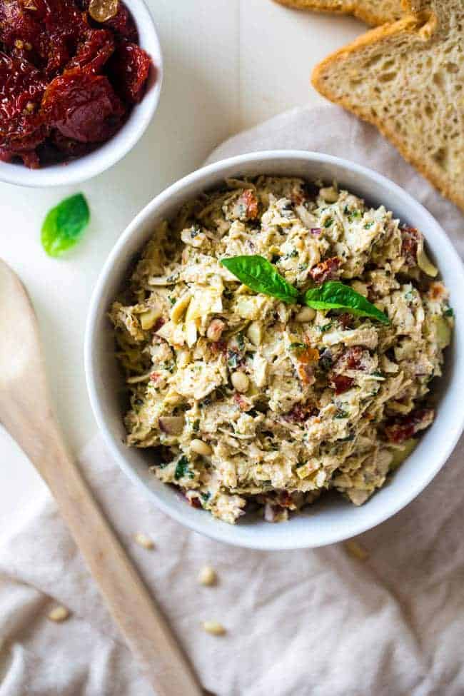 Healthy Greek Yogurt Chicken Salad without Mayo - This creamy chicken salad is made with Greek yogurt, basil, artichokes, pine nuts and sun dried tomatoes for a quick and easy meal that is secretly healthy! | Foodfaithfitness.com | @FoodFaithFit