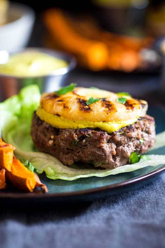 Paleo Burgers with Grilled Pineapple and Curry Cashew Cream - Topped with smooth and spicy curry cashew cream, grilled pineapple and wrapped with lettuce, this burger is a low carb, healthy meal for under 250 calories! | Foodfaithfitness.com | @FoodFaithFit