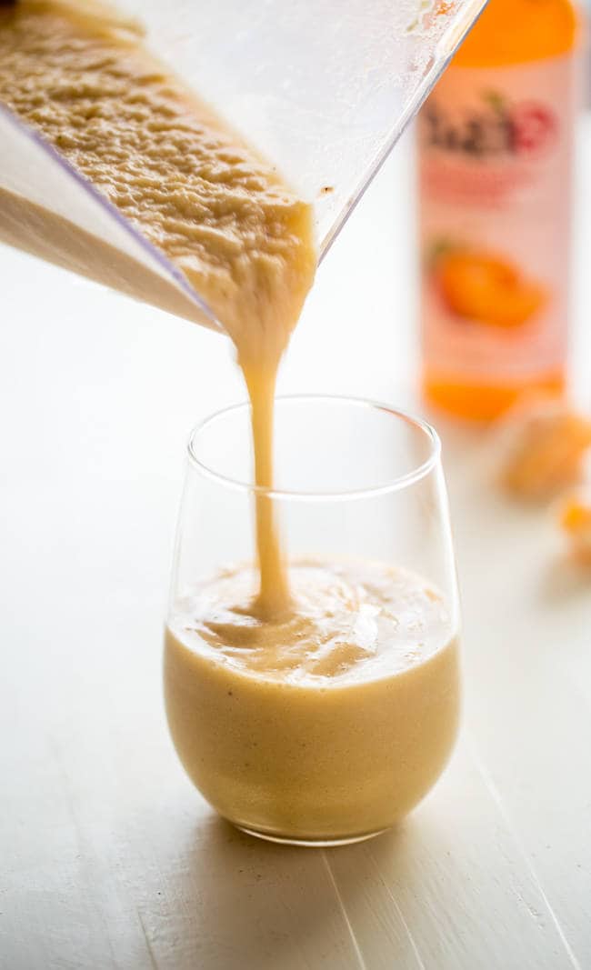 Banana Creamsicle Protein Smoothie - This orange smoothie is SO thick, creamy, and packed with vanilla protein powder so it tastes like a creamsicle! Ready in 5 minutes, loading with antioxidants and perfect for post workout recovery! | Foodfaithfitness.com | @FoodFaithFit
