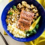 Caribbean Salmon Plantain Noodle Bowls - Plantain noodles are mixed with pineapple, spicy roasted cauliflower, sweet baked salmon and topped with coconut avocado sauce for a tropical, paleo meal! | Foodfaithfitness.com | @FoodFaithFit