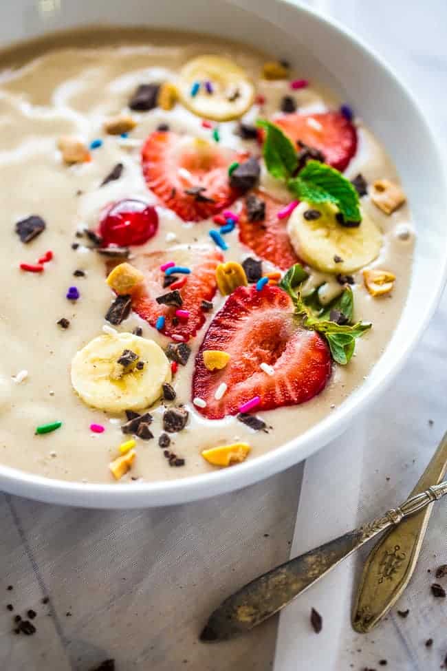 close up of vegan smoothie bowl with strawberries on top