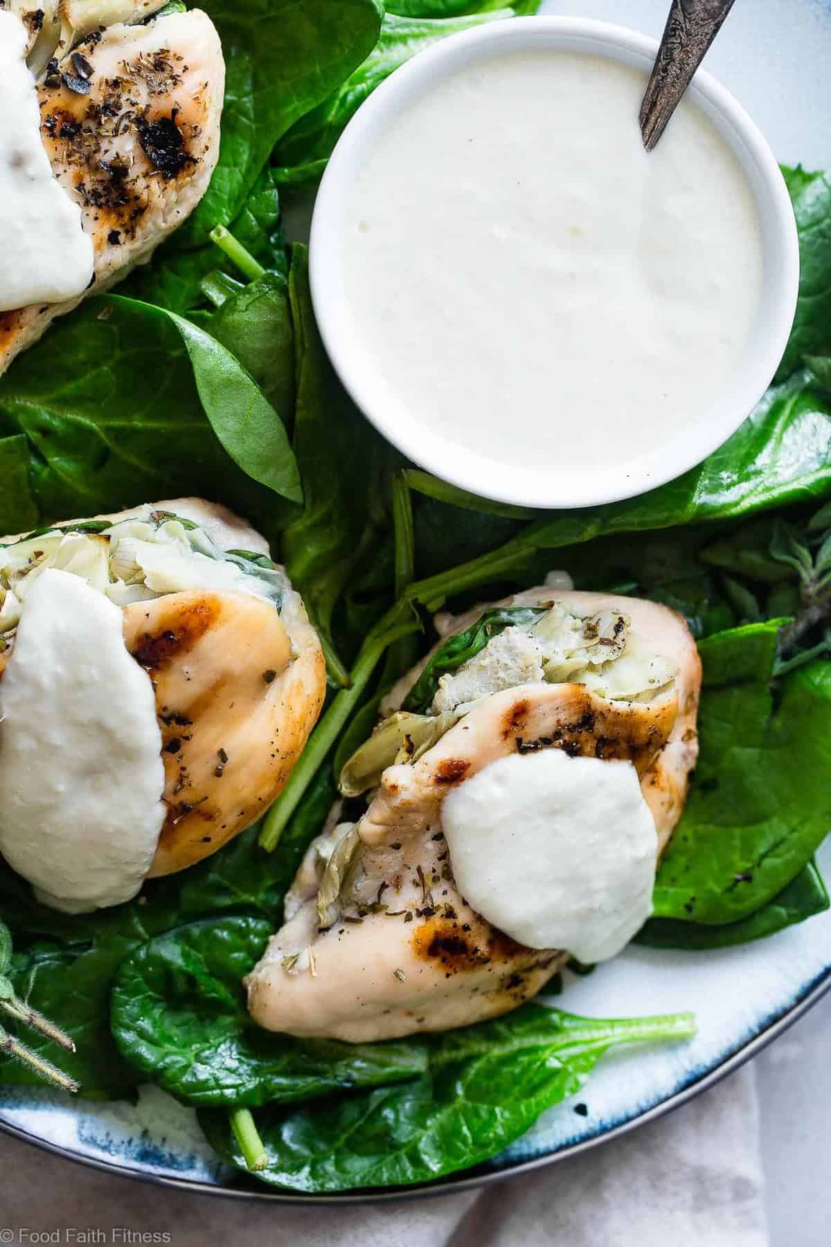 Spinach Artichoke Greek Yogurt Chicken - Chicken is stuffed, grilled and topped with a creamy, Parmesan Greek yogurt sauce! It's a healthy, low carb dinner that's perfect for a weeknight, and only 1 WW Freestyle point! | #Foodfaithfitness | #GreekYogurt #LowCarb #Healthy #Glutenfree #ChickenDinner