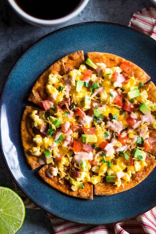 Homemade Healthy Breakfast Nachos - These spicy, healthy nachos are loaded with bacon, scrambled eggs, cheese and a Greek yogurt salsa for an easy, high protein & gluten free breakfast! | Foodfaithfitness.com | @FoodFaithFit