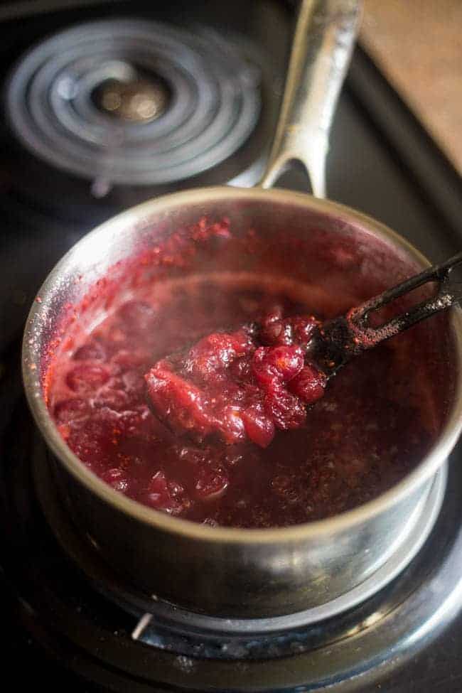 Paleo Maple Orange Cranberry Sauce - This healthy, homemade cranberry sauce uses only 3 ingredients and is Paleo friendly and refined- sugar free! It's ready in 30 minutes and is perfect for Thanksgiving! | Foodfaithfitness.com| @FoodFaithFit
