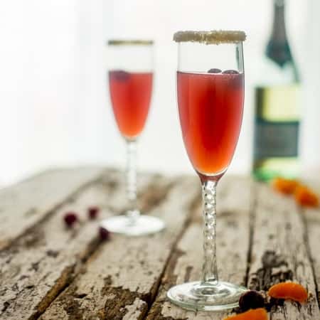 Champagne Orange Cranberry Cocktail - This cranberry cocktail has a touch of fresh orange juice and a splash of champagne to make it bubbly! It's so easy to make and perfect for holiday entertaining! | Foodfaithfitness.com | @FoodFaithFit
