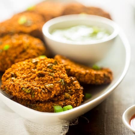 Vegan Buffalo Patties with Avocado Dip - These patties taste just like buffalo chicken, but they're totally meat free and made with cauliflower and quinoa! They're a spicy, crunchy and creamy appetizer for game day! | Foodfaithfitness.com | @FoodFaithFit