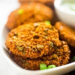 Vegan Buffalo Patties with Avocado Dip - These patties taste just like buffalo chicken, but they're totally meat free and made with cauliflower and quinoa! They're a spicy, crunchy and creamy appetizer for game day! | Foodfaithfitness.com | @FoodFaithFit