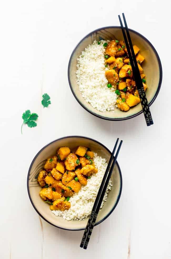 Whole 30 Mango Chicken with Coconut Cauliflower Rice - This paleo mango chicken is served over coconut cauliflower rice for a quick, easy and healthy spin on take-out that is ready in 30 mins! Recipe has a vegan option too! | Foodfaithfitness.com | @FoodFaithFit