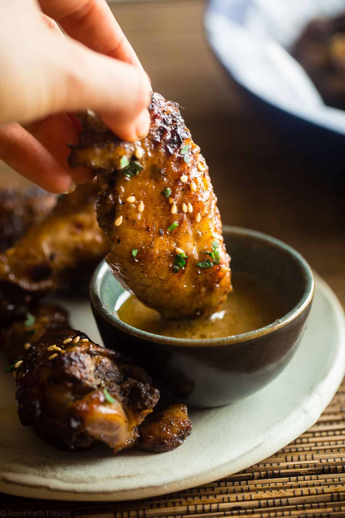 dipping paleo whole30 chicken wings in sauce