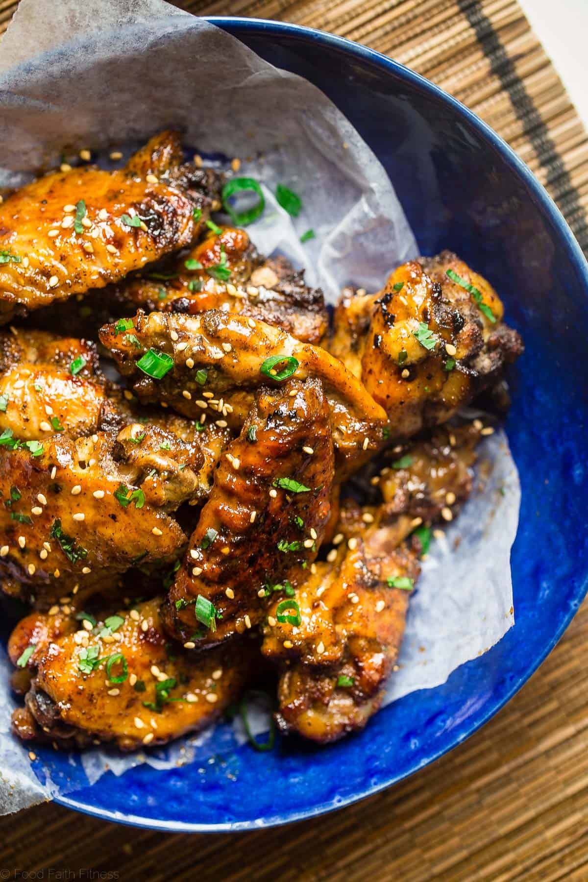 close up photo of slow cooker wings in a blue bowl