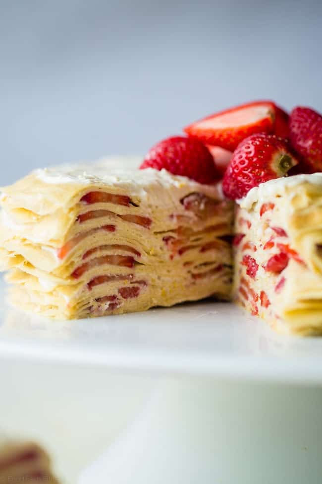 Strawberry Lemon Paleo Crepe Cake with Coconut Cream - This cake is made out of paleo crepes layered with rich, sweet lemon coconut cream and fresh strawberries. It's a gluten free dessert, that's perfect for a spring brunch or Mothers day! | Foodfaithfitness.com | @FoodFaithFit