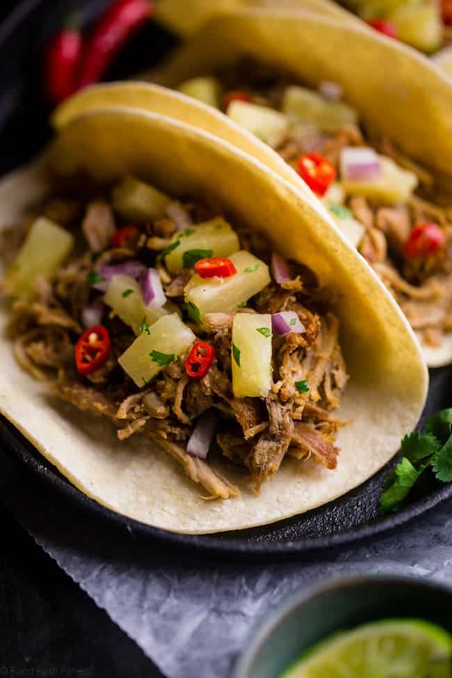Slow Cooker Green Curry Pork Tacos - These pork tacos have the spicy-sweet taste of Thai curry and pineapple salsa! They're made in the slow cooker for an easy, gluten free and healthy meal! | Foodfaithfitness.com | @FoodFaithFit