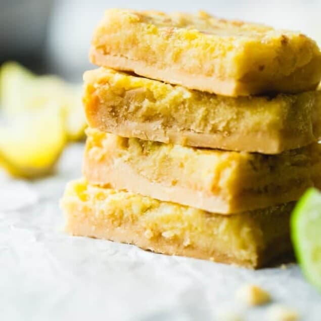 Tropical Paleo Lemon Bars - These paleo lemon bars use lime juice and macadamia nuts to give the classic dessert a tropical twist. They're a healthier, gluten and grain free dessert that's only 7 ingredients and so easy to make! | Foodfaithfitness.com | @FoodFaithFit