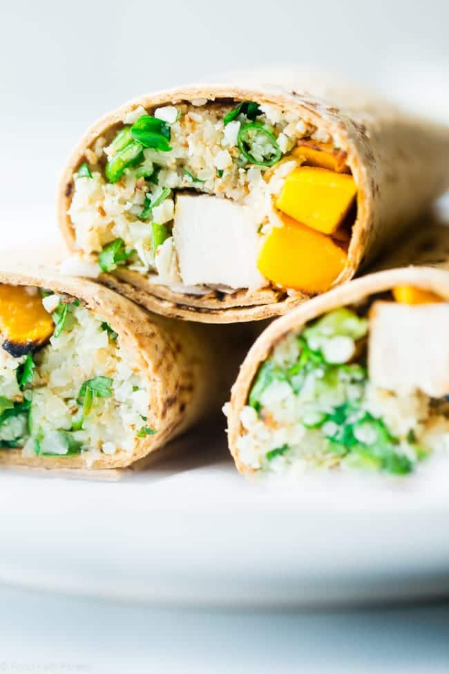 Grilled Mango Chicken Cauliflower Rice Wrap - This healthy, smoky-sweet wrap has grilled chicken, mango and ginger cauliflower rice! It's a quick and easy portable meal that's big on flavor and perfect for lunchboxes! Gluten free option included! | Foodfaithfitness.com | @FoodFaithFit