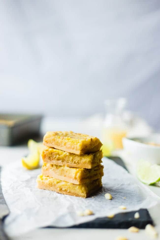Tropical Paleo Lemon Bars - These paleo lemon bars use lime juice and macadamia nuts to give the classic dessert a tropical twist. They're a healthier, gluten and grain free dessert that's only 7 ingredients and so easy to make! | Foodfaithfitness.com | @FoodFaithFit