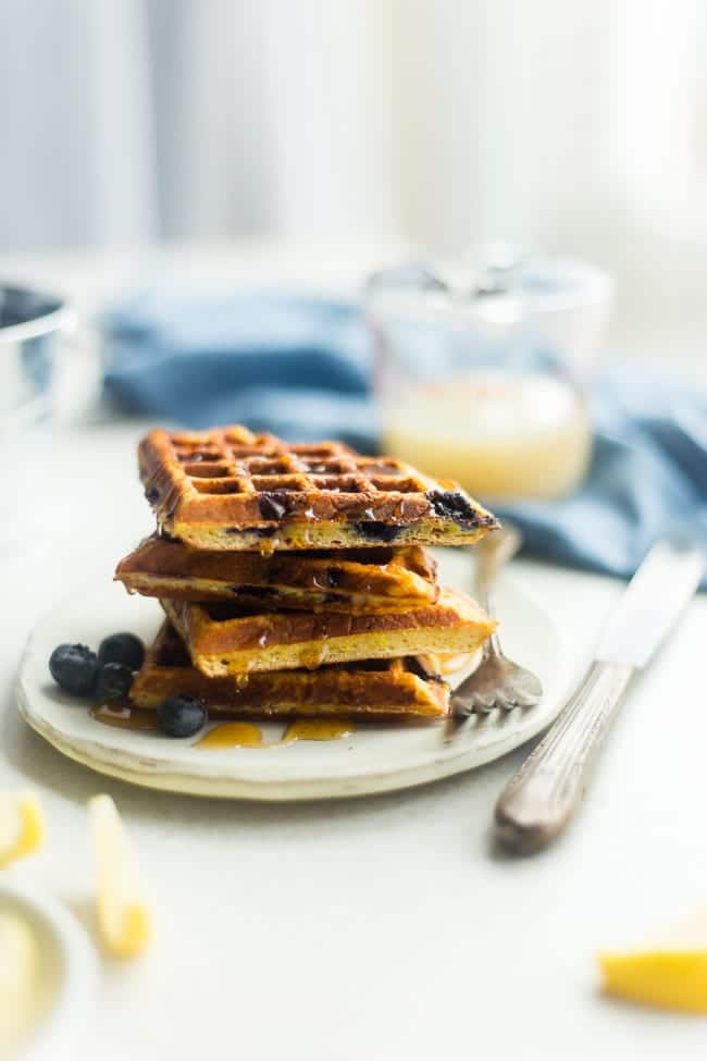 Single-Serve Lemon Blueberry Paleo Protein Waffles - These single-serve protein waffles are studded with juicy blueberries and have a 5 minute lemon sauce! Perfect for a paleo friendly, gluten free breakfast on busy mornings! | FoodFaithfitness.com | @FoodFaithFit