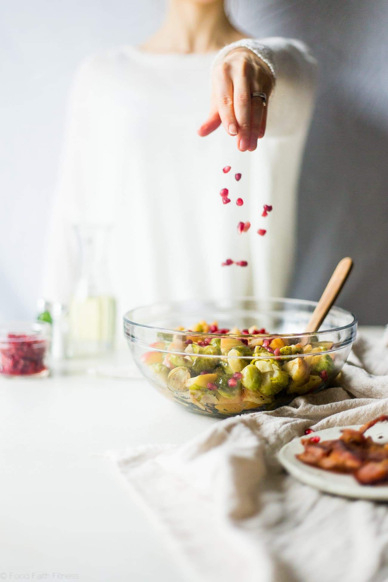 Superfood Roasted Brussels Sprouts with Bacon - These salty-sweet roasted Brussels sprouts are tender, crispy and have a surprise superfood pomegranate crunch! They're the perfect, paleo-friendly healthy Thanksgiving side! | Foodfaithfitness.com | @FoodFaithFit
