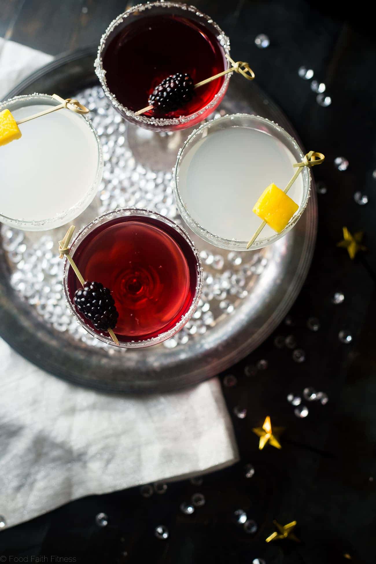 3 Ingredient Skinny Champagne Cocktails - Both of these blackberry raspberry and mango coconut sparkling champagne cocktails are under 150 calories and are naturally sweetened! Perfect for a healthy NYE! | Foodfaithfitness.com | @FoodFaithFit