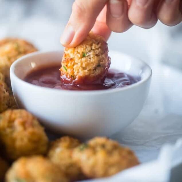 Baked Cauliflower Tater Tots - A gluten free, lower carb version of the classic comfort food that are crispy on the outside and soft on the inside. You'll never know they're healthy and made from hidden veggies! | Foodfaithfitness.com | @FoodFaithFit
