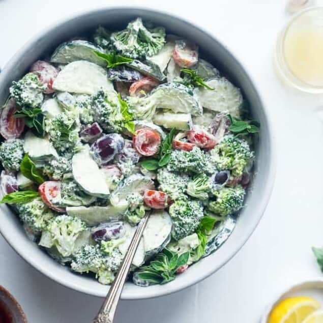 Greek Healthy Broccoli Salad - This low carb, raw broccoli salad is so creamy you'll never know it's vegan, paleo and whole30 compliant! It's an easy side dish that's perfect for spring potlucks! | Foodfaithfitness.com | @FoodFaithFit