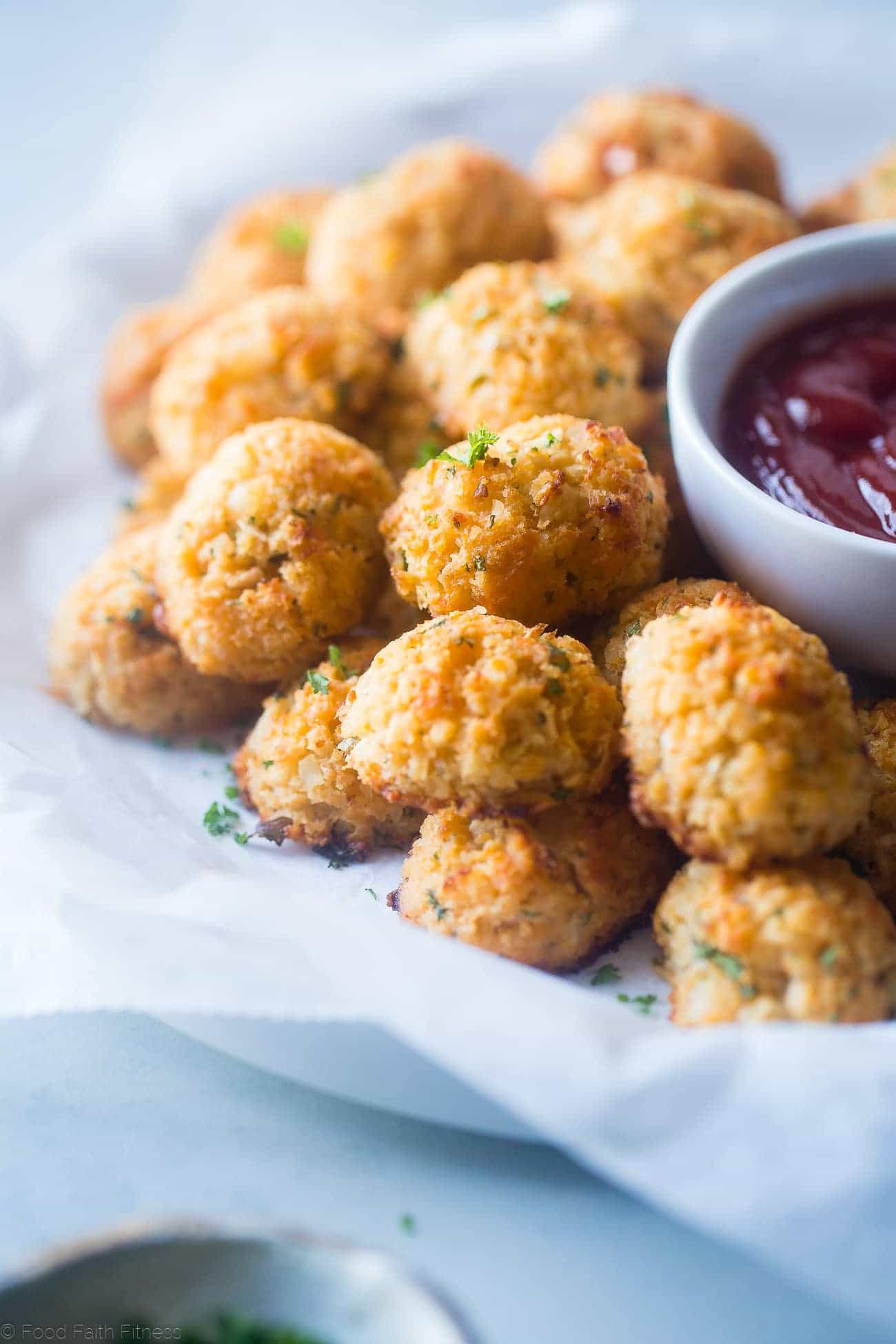 Baked Cauliflower Tater Tots - A gluten free, lower carb version of the classic comfort food that are crispy on the outside and soft on the inside. You'll never know they're healthy and made from hidden veggies! | Foodfaithfitness.com | @FoodFaithFit