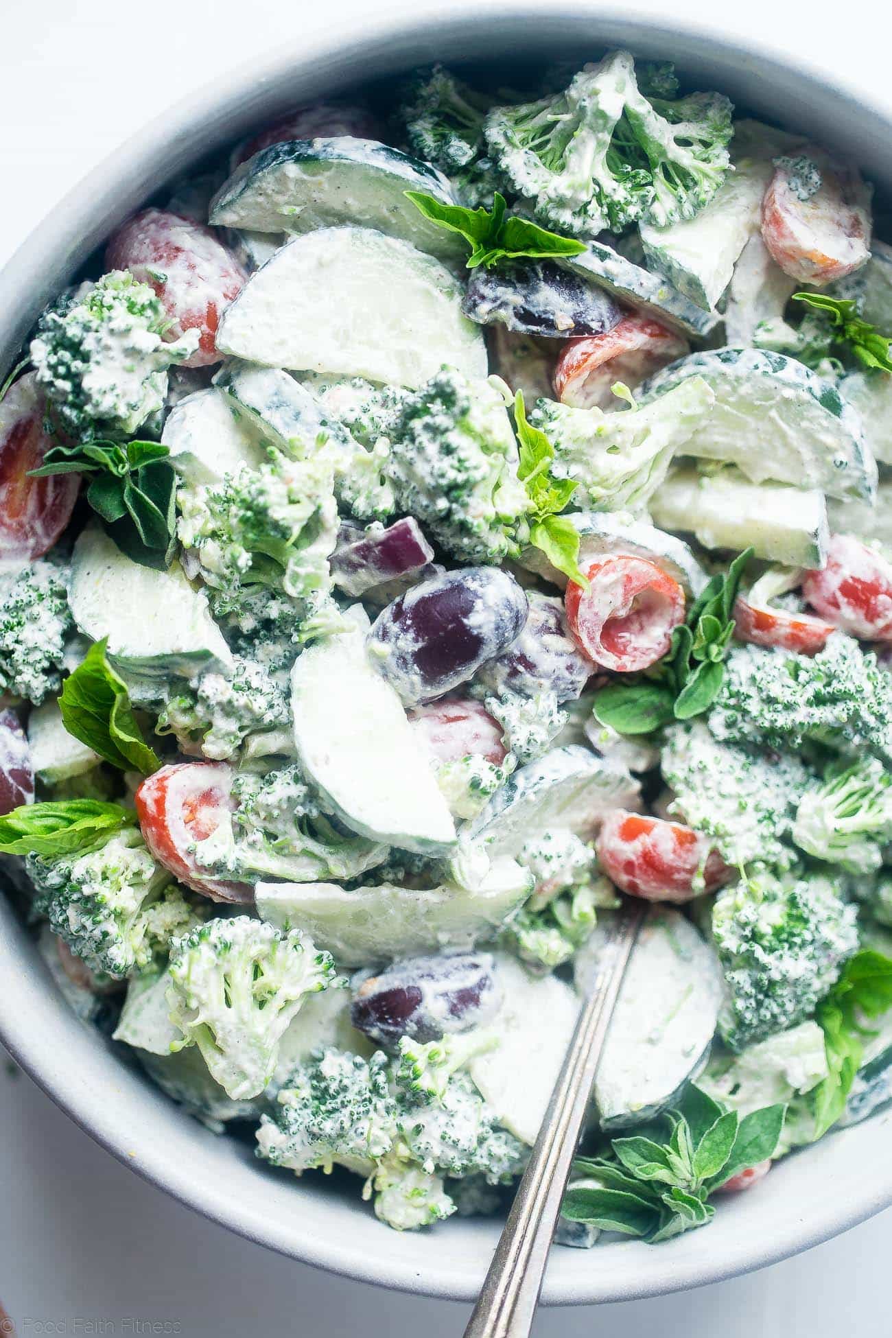 Greek Paleo Broccoli Salad - This low carb, raw broccoli salad is so creamy you'll never know it's vegan, paleo and whole30 compliant! It's an easy side dish that's perfect for spring potlucks! | Foodfaithfitness.com | @FoodFaithFit