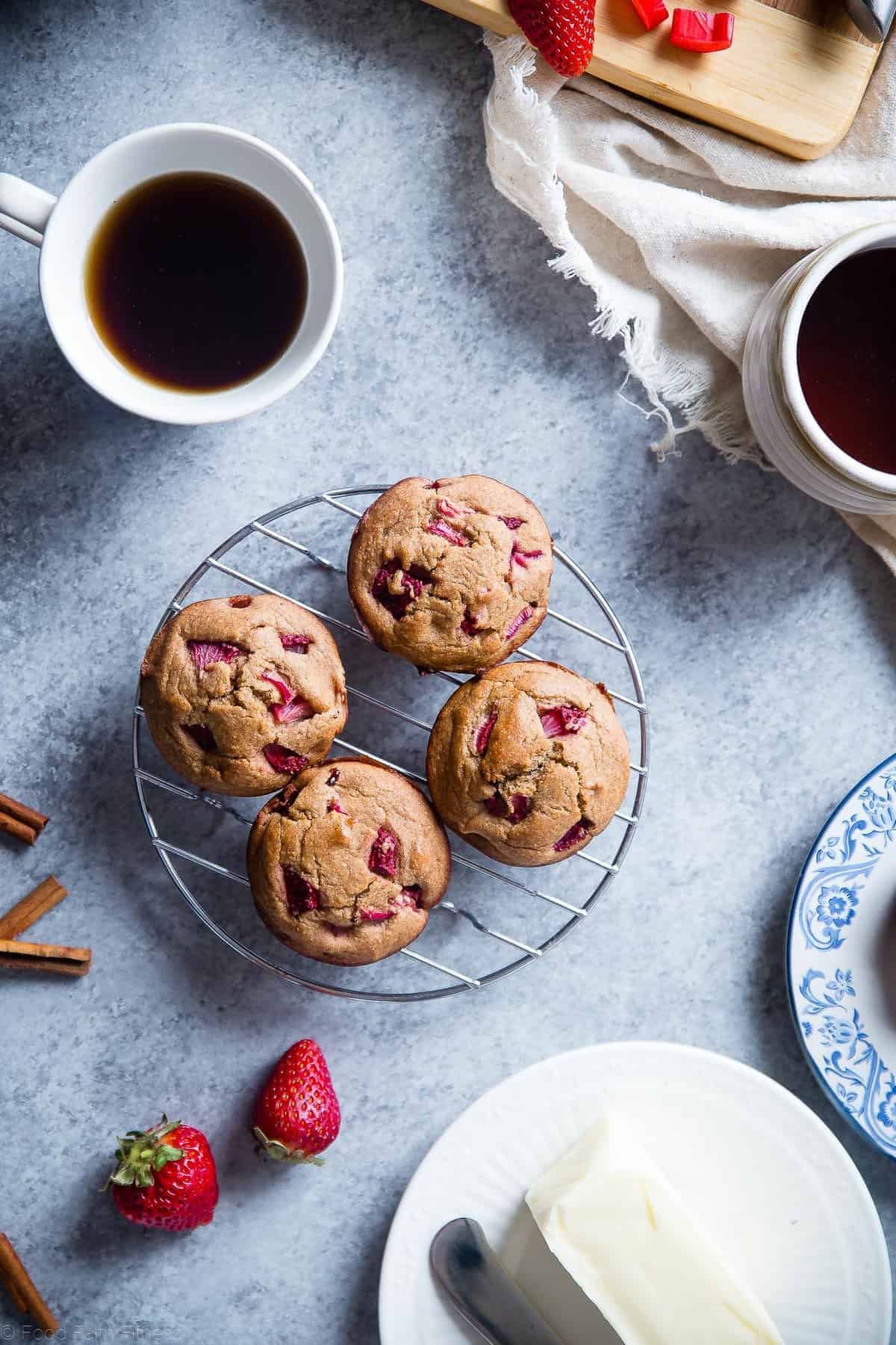 Strawberry Rhubarb Muffins on a cooling rack with coffee on the side