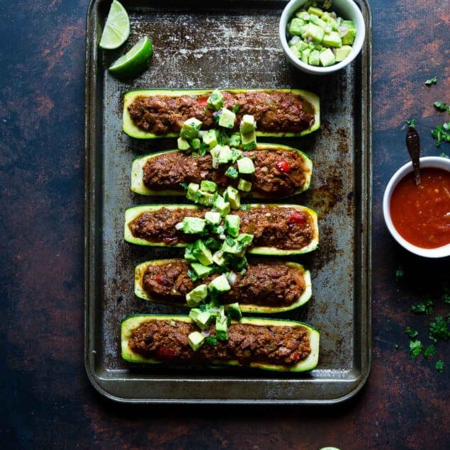 Tuna Zucchini Boats on a baking tray with lime and sauce