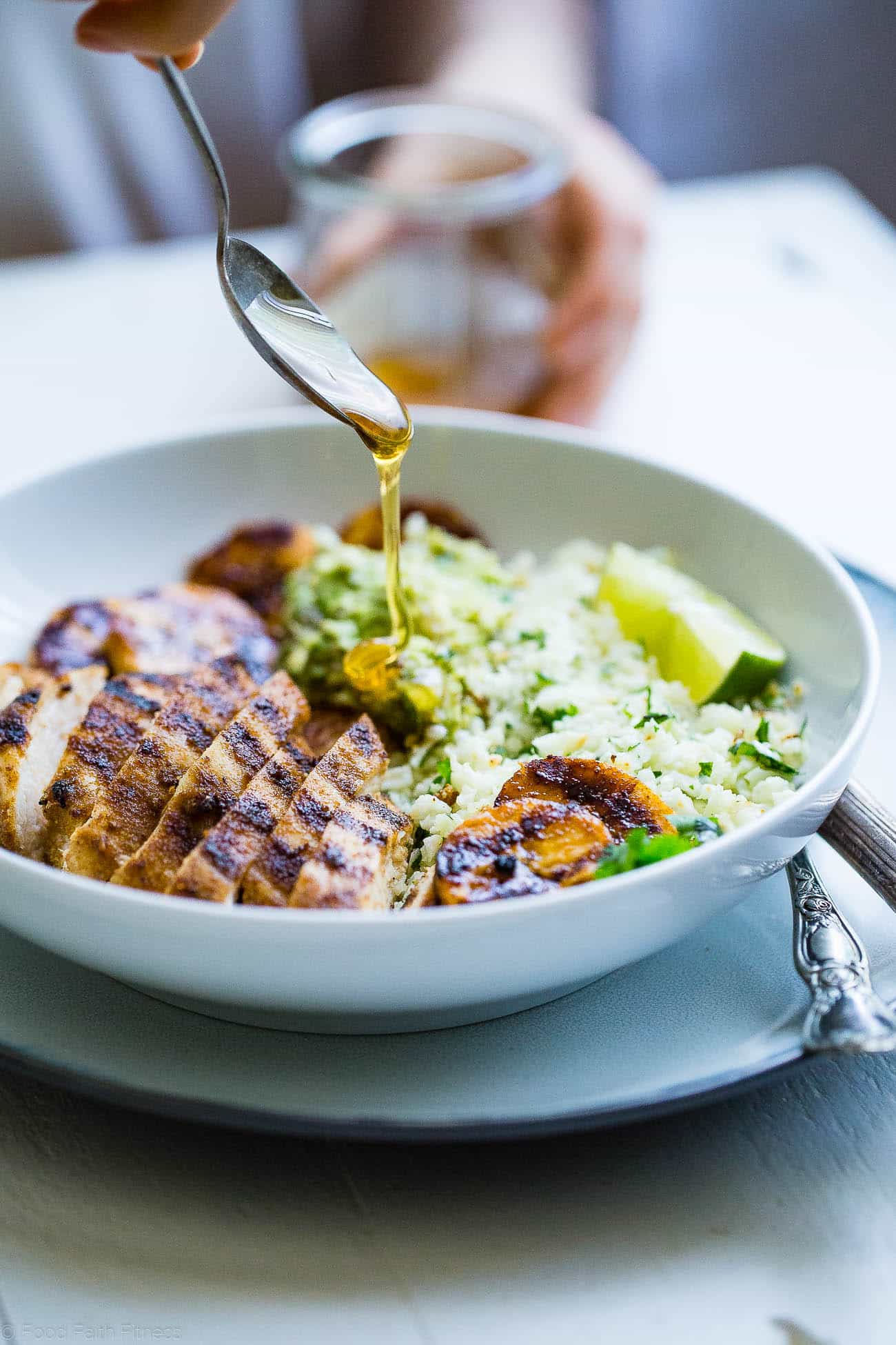 Caribbean Chicken Bowls - These paleo-friendly bowls have grilled plantains, cauliflower rice and avocado! A healthy, gluten free summer meal for under 500 calories! | #Foodfaithfitness | #Paleo #Glutenfree #Healthy #chickenrecipe