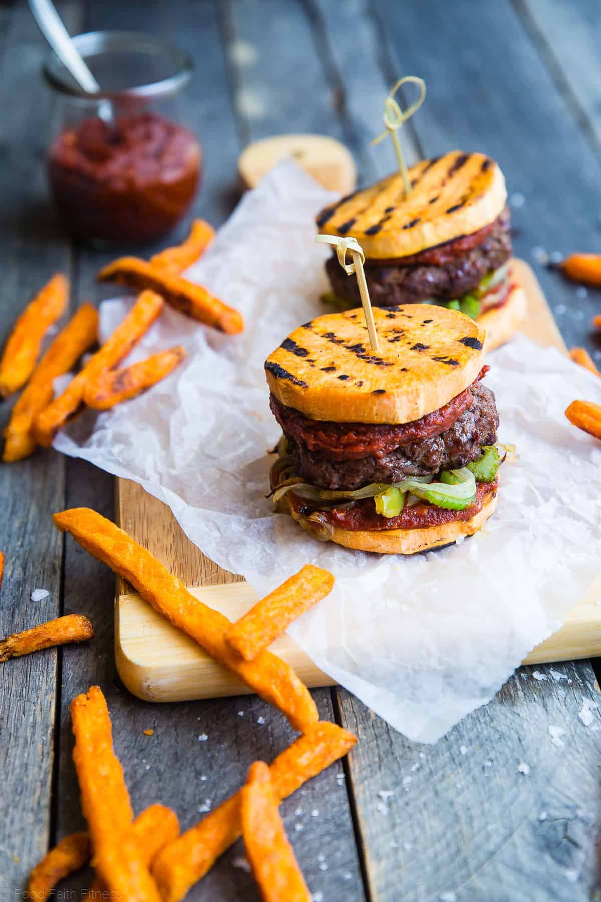 sweet potato bun cajun burger on a meat serving block with fries