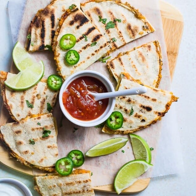 Grilled Mexican Lentil Quesadillas Overhead on a cutting board. Recipe on Foodfaithfitness.com
