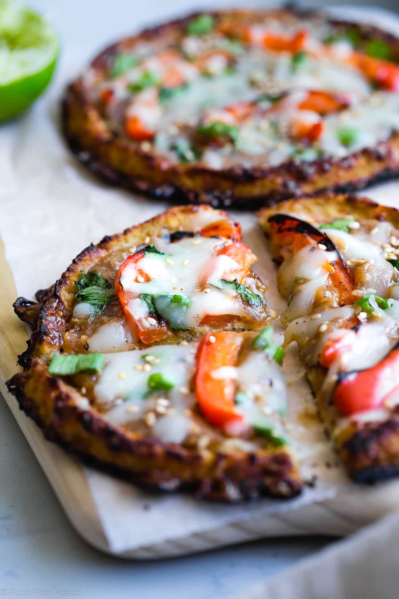 Close up of Thai cauliflower pizza with melting cheese. Recipe on Foodfaithfitness.com