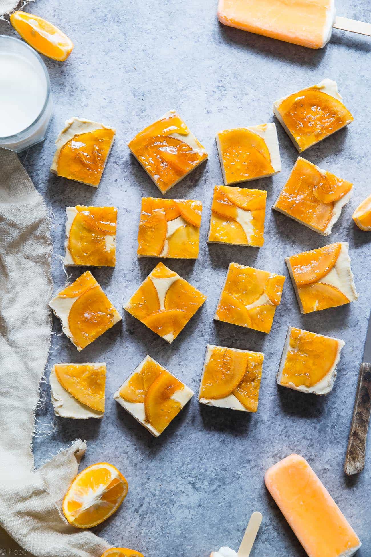 Healthy No Bake Creamsicle Cheesecake Bars - These raw vegan cheesecake bars have a creamy vanilla base, an orange topping and taste like a creamsicle! They're a dairy and gluten free treat for the Summer! | Foodfaithfitness.com | @FoodFaithFit
