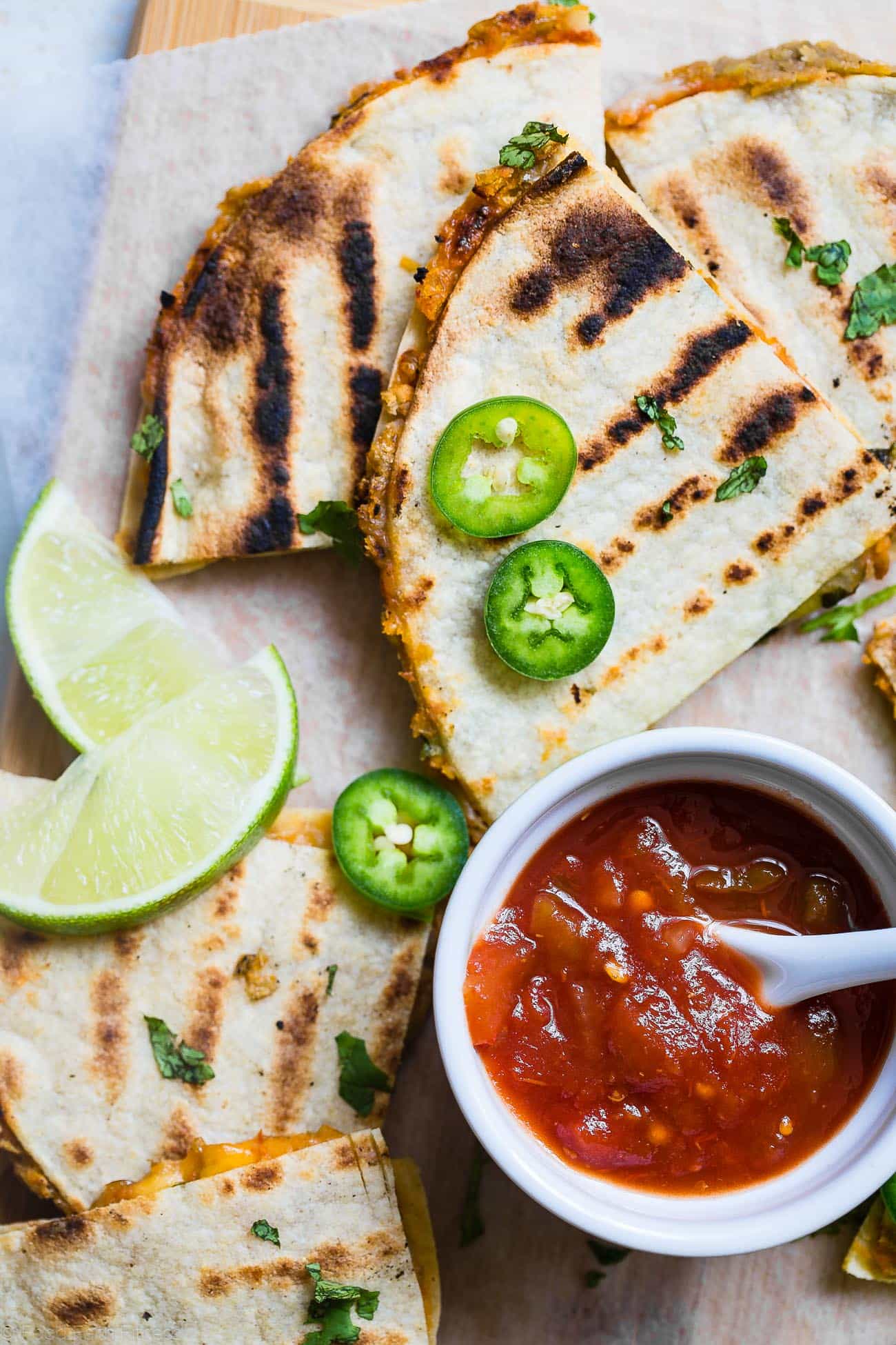 Close up photo of Grilled Mexican Lentil Quesadillas Overhead on a cutting board. Recipe on Foodfaithfitness.com