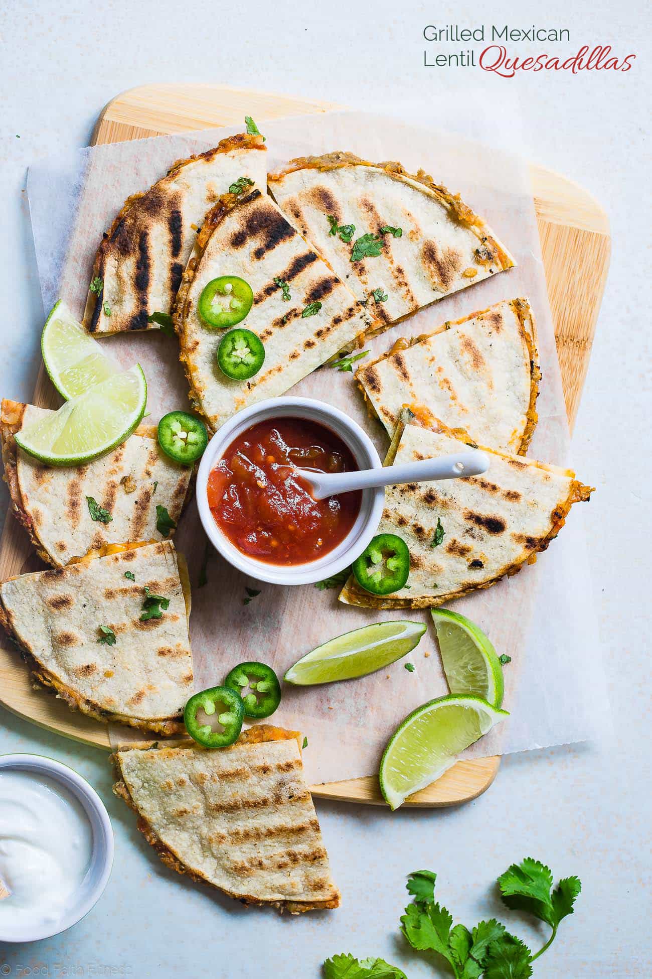 Grilled Mexican Lentil Quesadillas stacked on a cutting board. Recipe on Foodfaithfitness.com