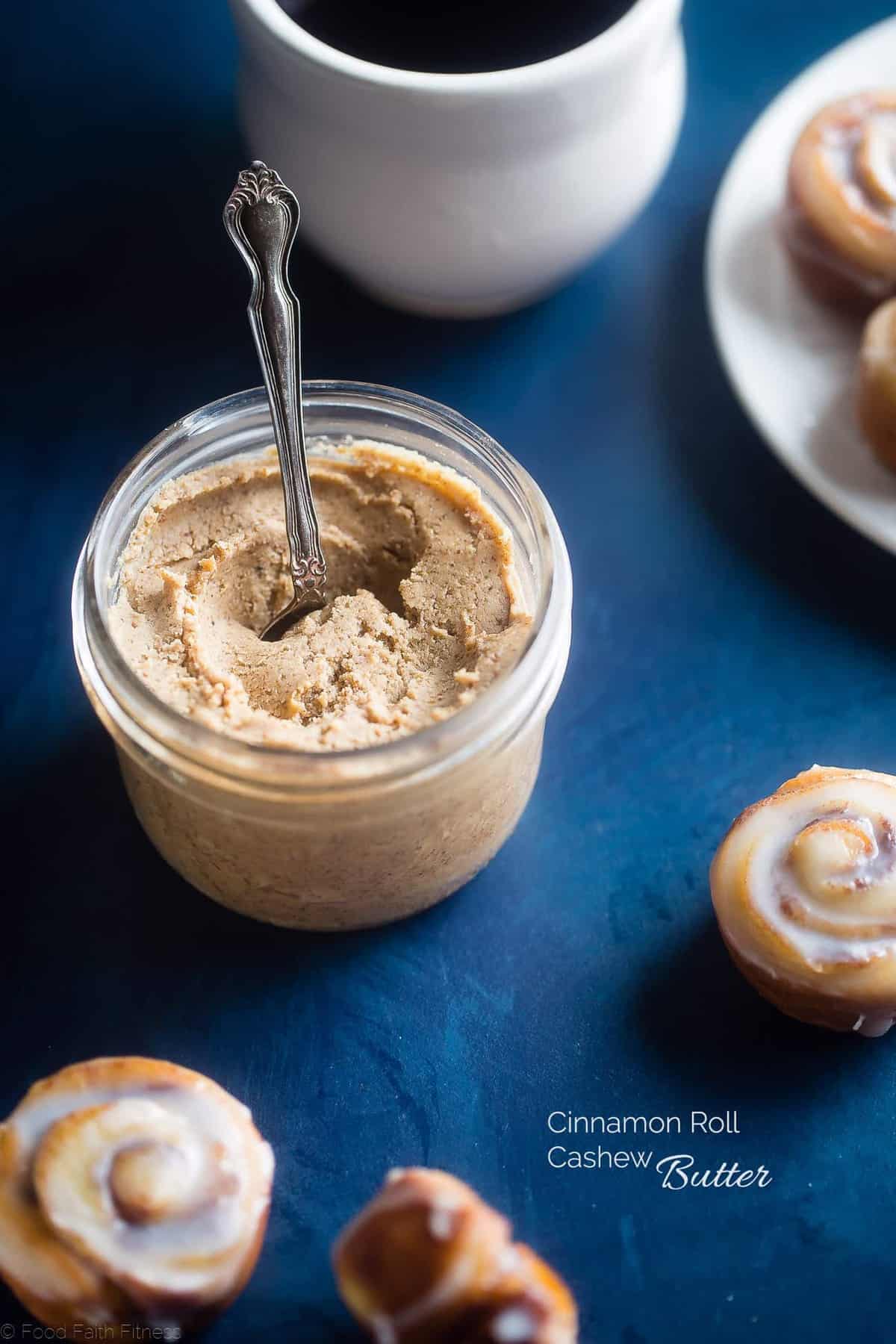 Jar of homemade cashew butter with mini cinnamon rolls around it. Recipe on Foodfaithfitness.com