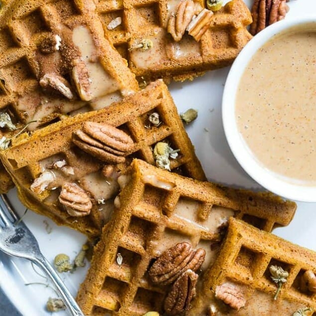 The BEST Pumpkin Spice Paleo Waffles with Pumpkin Cream Sauce - SO light, crispy and airy that you will NEVER believe that these are vegan friendly and gluten, grain, dairy AND sugar free! | Foodfaithfitness.com | @FoodFaithFit