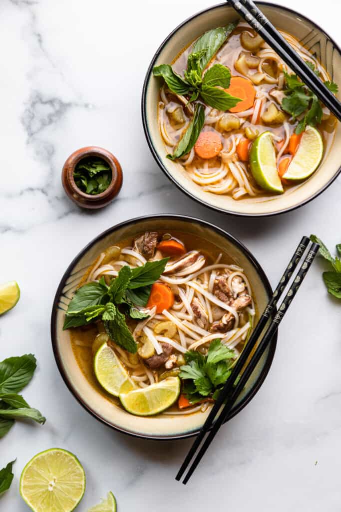 two bowls of Chicken Pho Recipe on a table