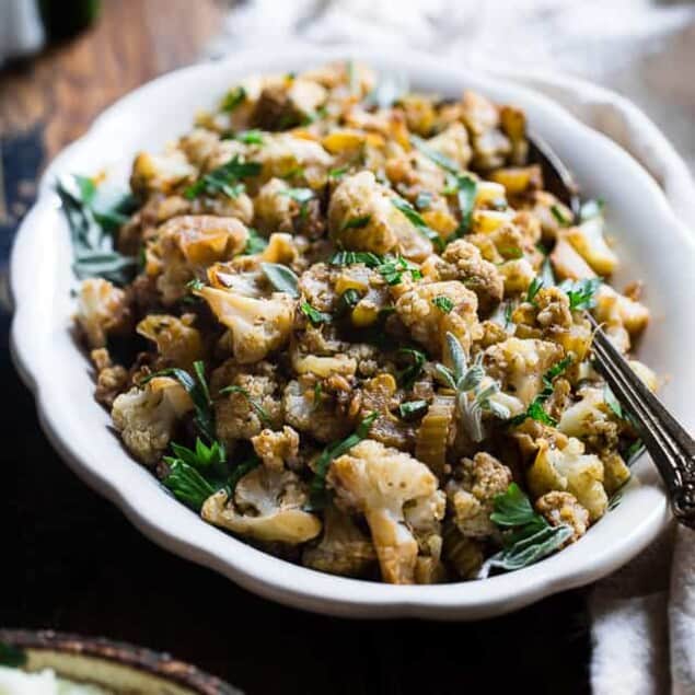 Low Carb Cauliflower Stuffing - Made entirely from vegetables but has all the flavor of traditional bread stuffing! It's super easy, whole30 compliant, paleo, vegan, gluten free and SO delicious! Perfect for Thanksgiving or Christmas! | Foodfaithfitness.com | @FoodFaithFit
