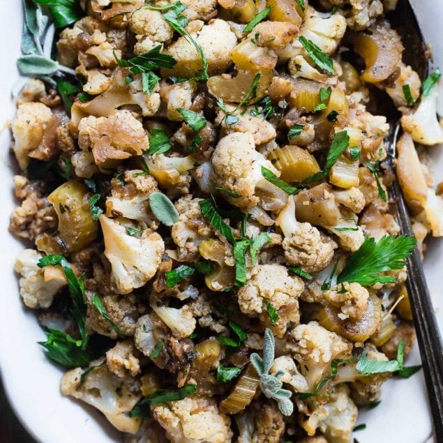 Low Carb Cauliflower Stuffing - This low carb stuffing recipe is made entirely from vegetables but has all the flavor of traditional bread stuffing! It's super easy, whole30 compliant, paleo, vegan, gluten free and SO delicious! Perfect for Thanksgiving or Christmas! | Foodfaithfitness.com | @FoodFaithFit