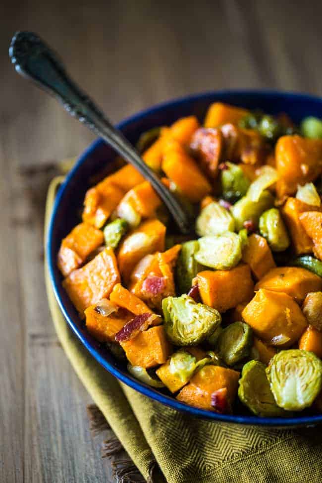 oven roasted maple bacon brussels sprouts and sweet potatoes in a bowl