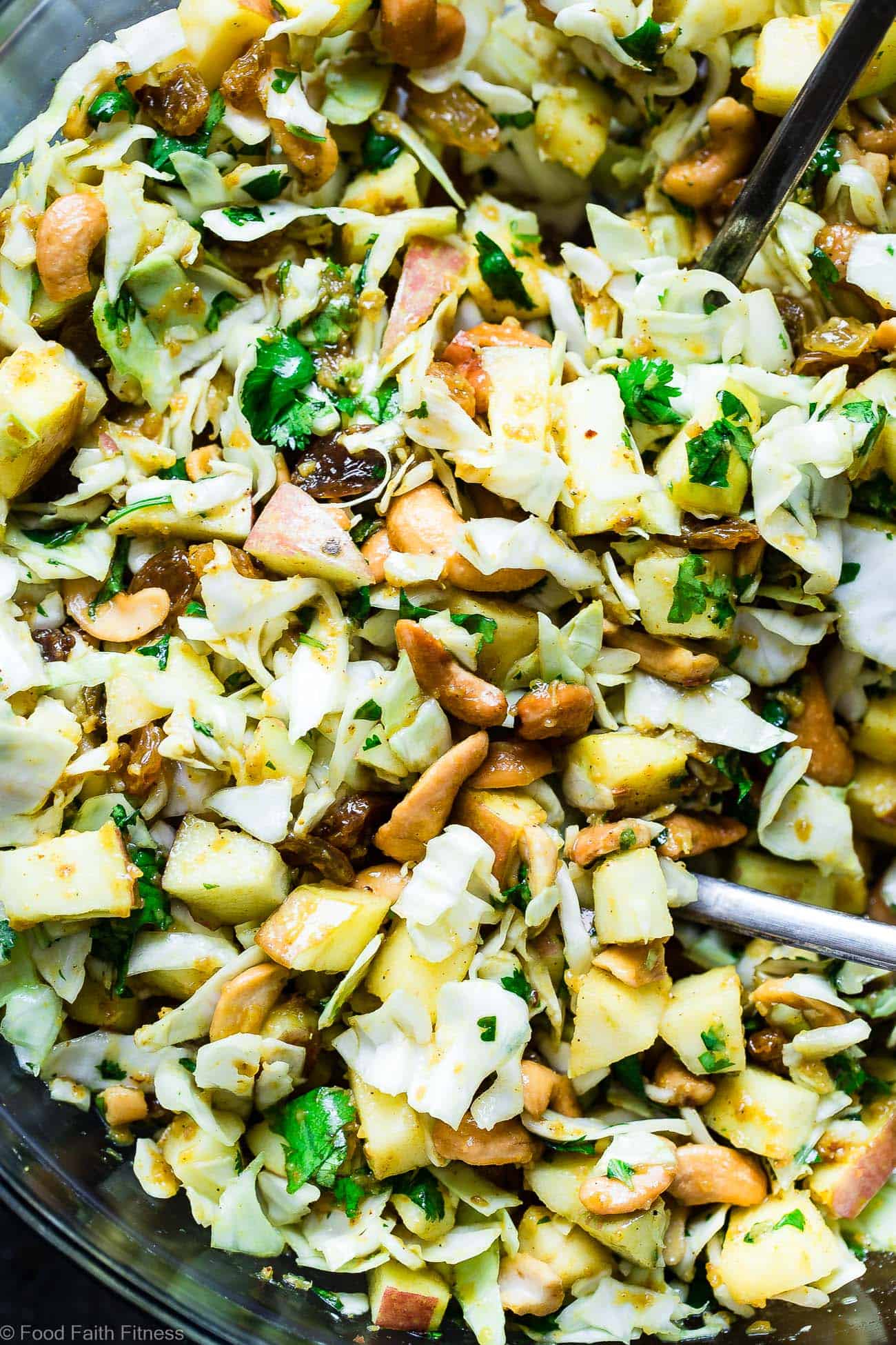 Curry Cashew Shredded Cabbage Salad with Apples - A sugar and gluten free healthy raw cabbage salad that is mixed with a creamy curry dressing and crunchy cashews! A healthy, paleo and whole30 side dish that everyone will love! | Foodfaithfitness.com | @FoodFaithFit