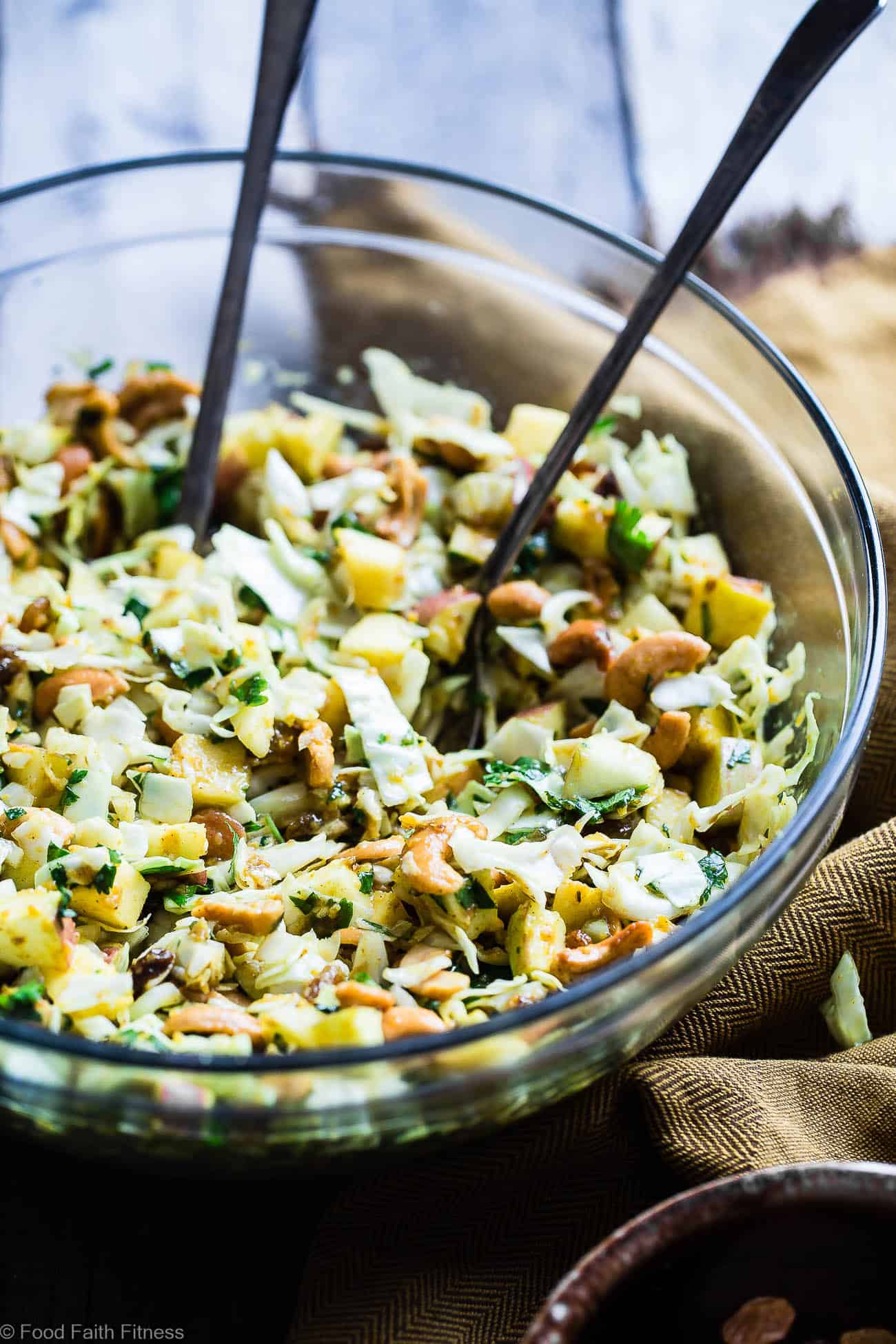 Curry Cashew Shredded Cabbage Salad with Apples - A sugar and gluten free healthy easy cabbage salad recipe that is mixed with a creamy curry dressing and crunchy cashews! A healthy, paleo and whole30 side dish that everyone will love! | Foodfaithfitness.com | @FoodFaithFit