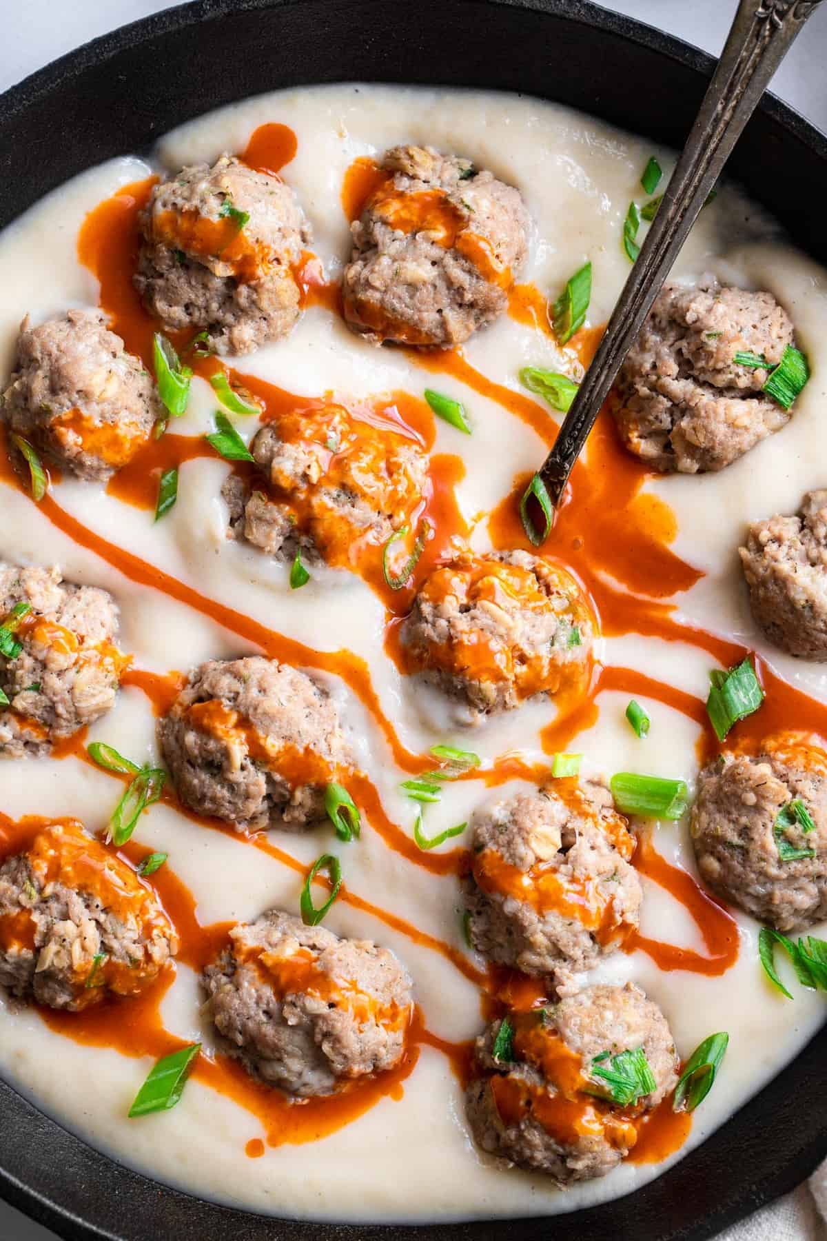 close up of healthy buffalo chicken meatballs in a frying pan
