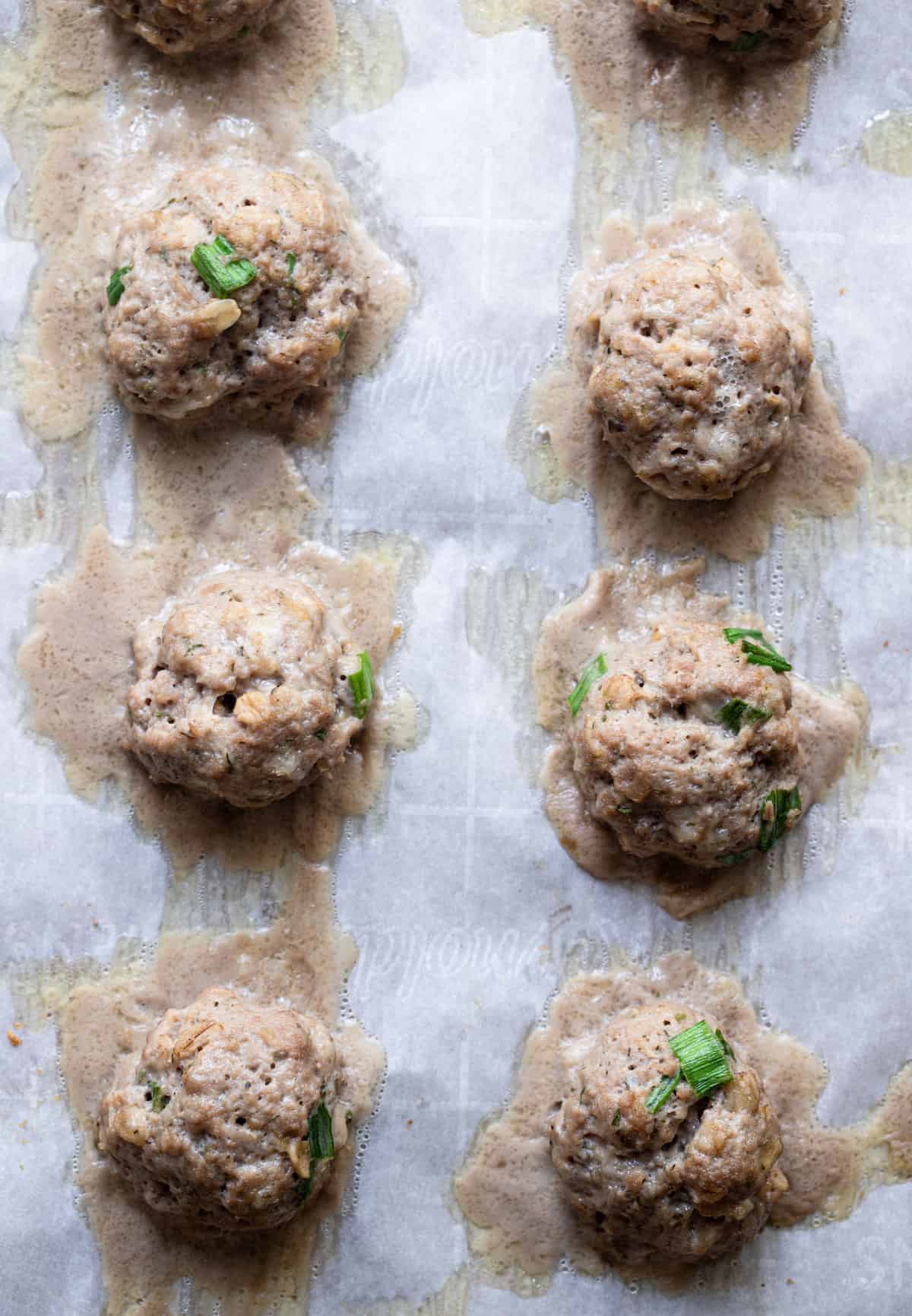 baked turkey meatballs on a cookie sheet