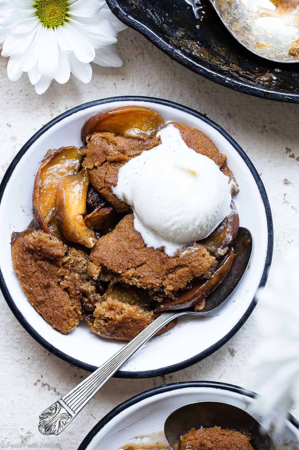 close up of a piece of paleo peach cobbler with ice cream on top