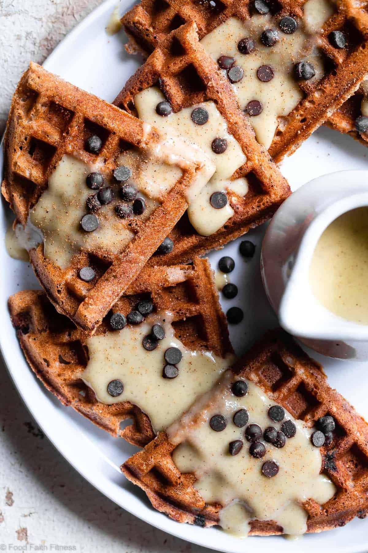 Gluten Free Vegan Waffles with Eggnog "Cream" Sauce - These FLUFFY vegan waffles are studded with chocolate chips and covered with a healthy eggnog "cream" sauce! A delicious holiday breakfast that you can make ahead for easy mornings! | #Foodfaithfitness | #Glutenfree #Vegan #Dairyfree #Eggfree #Healthy