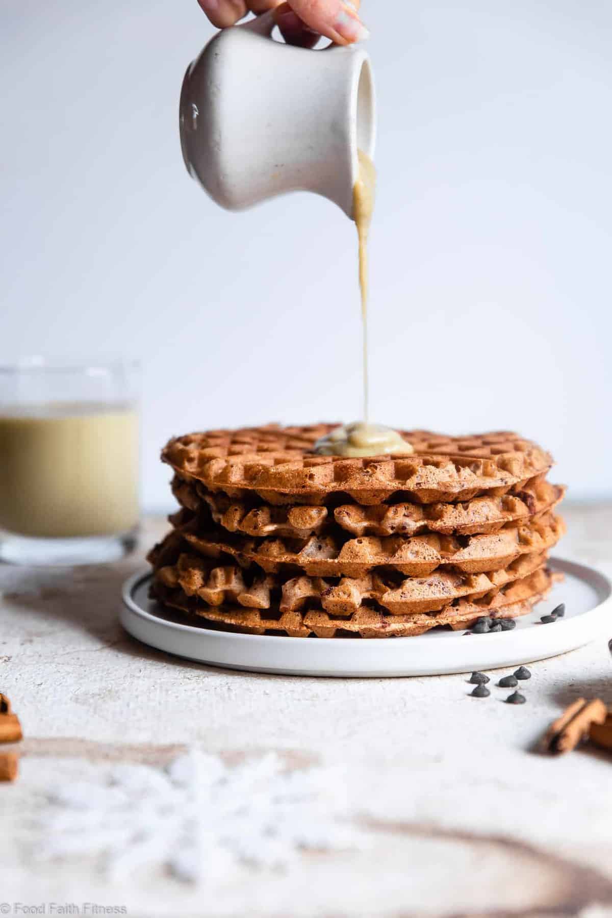 Gluten Free Vegan Waffles with Eggnog "Cream" Sauce - These FLUFFY vegan waffles are studded with chocolate chips and covered with a healthy eggnog "cream" sauce! A delicious holiday breakfast that you can make ahead for easy mornings! | #Foodfaithfitness | 