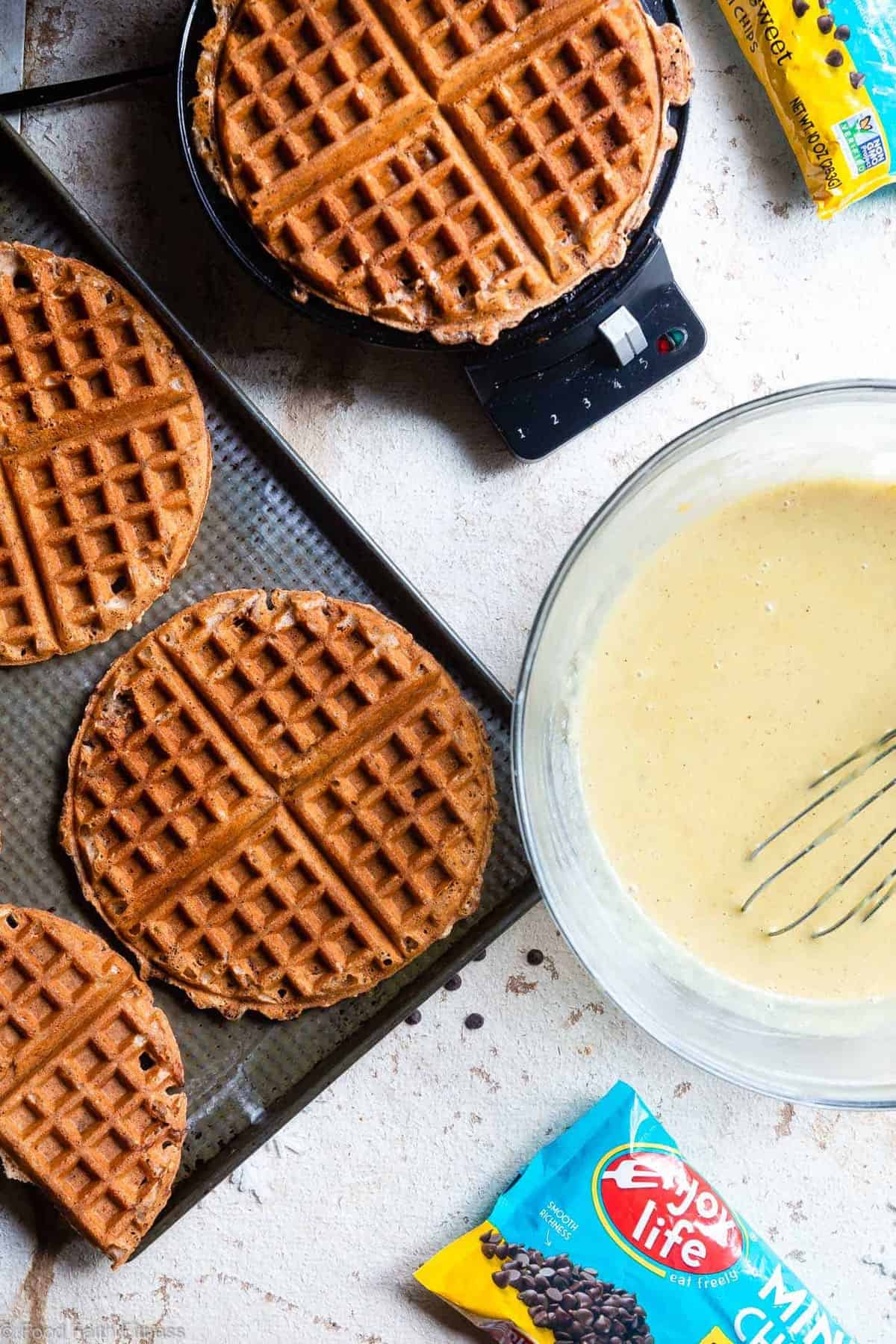 Gluten Free Easy Vegan Waffles with Eggnog "Cream" Sauce - These FLUFFY vegan waffles are studded with chocolate chips and covered with a healthy eggnog "cream" sauce! A delicious holiday breakfast that you can make ahead for easy mornings! | #Foodfaithfitness | 